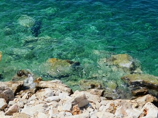 A rocky shore with emerald waters, in Attica, Greece