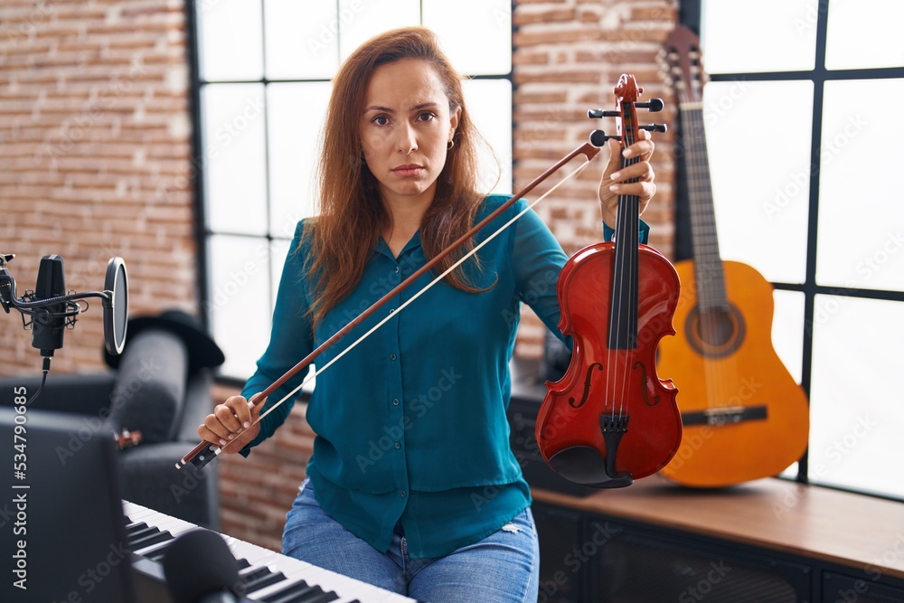 Poster Brunette woman playing violin depressed and worry for distress, crying angry and afraid. sad expression.