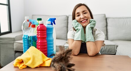 Middle age hispanic woman working as housekeeper at home