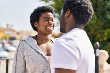 Fototapeta premium African american man and woman couple speaking together at street
