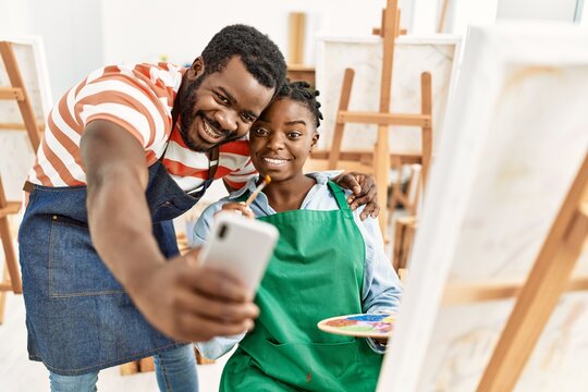 African american painter couple smiling happy making selfie by the smartphone at art studio.