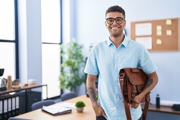 African american man business worker smiling confident holding leather briefcase at office