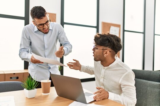 Two Hispanic Men Business Workers Arguing At Office