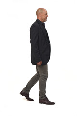  side view of a man with blazer and jeans walking on white background,