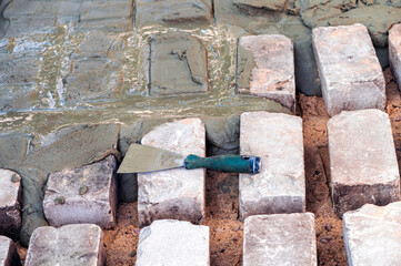 concreting the foundations of the garden terrace floor, trowel on bricks