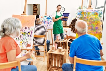 Group of middle age students having draw lesson at art studio.