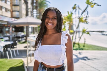 Young african american girl smiling happy standing at the promenade © Krakenimages.com