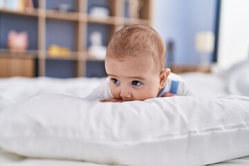 Adorable baby relaxed lying on bed at bedroom