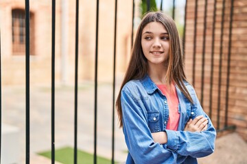 Adorable girl smiling confident standing with arms crossed gesture at street