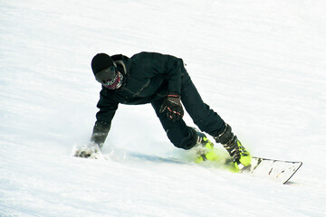 Snowboarder on skies downhill. Special winter sports combination .Types on snowboards and ski shoe...
