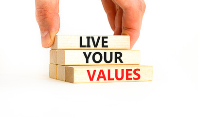 Live your values symbol. Concept words Live your values on wooden blocks. Businessman hand. Beautiful white table white background. Business, psychological and live your values concept. Copy space.