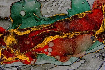 Mid section filled with floating gold foil on Alcohol ink fluid abstract texture fluid art with gold glitter and liquid.