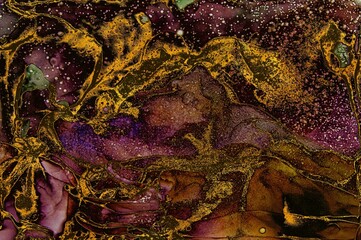 Small drops of white ink and golden dust on areas on Alcohol ink fluid abstract texture fluid art with gold glitter and liquid.