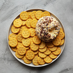 Homemade Cheese Ball with Cream Cheese and Green Onions on a Plate, top view. Flat lay, overhead, from above.