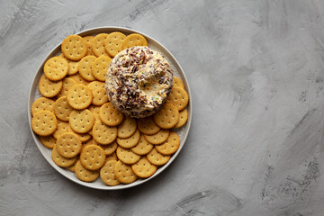 Homemade Cheese Ball with Cream Cheese and Green Onions on a Plate, top view. Flat lay, overhead, from above. Space for text.