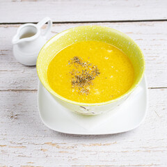 pumpkin soup in white bowl