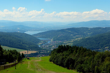 Fototapeta premium Panoramic view from Zar Mountain, Poland. View of Beskidy Mountains, Zywieckie Lake. Small Beskid region of Poland