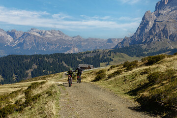 Fototapeta na wymiar Bikers on mountainous trail. Summer Trekking in Dolomites