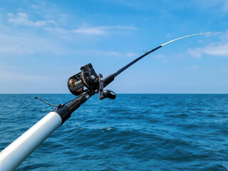 Fishing rod and reel on blue Lake Michigan water