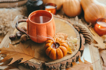 Smoke from an extinguished candle and a cup of tea, autumn composition