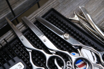 Fototapeta premium Vintage barber shop tools on old wooden background and rubber mat