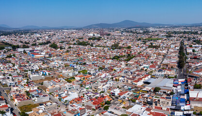 Aerial: panoramic view of the mountains over the town. Drone view