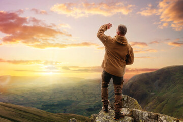Bearded Man reaching the destination  and on the top of mountain  at sunset on autumn day  Travel ...