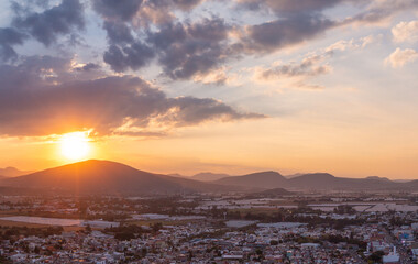 Aerial: beautiful sunset in the mountains and the city. Drone view