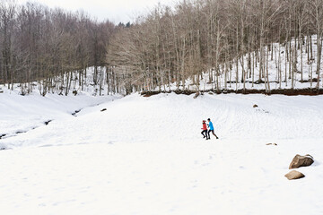 Running couple in winter forest.