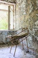 Rusty cradle in the maternity ward of Prypiat, Chernobyl exclusion zone, Ukraine