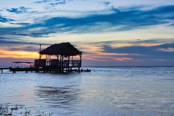 sunset with over water bungalow