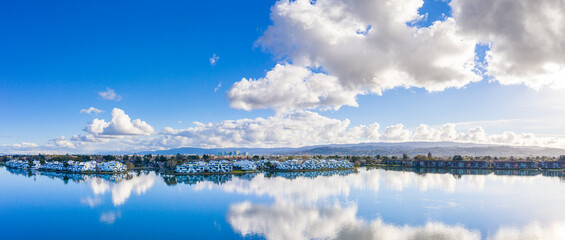 Aerial: scenic view of a lagoon and a city in California. Drone view