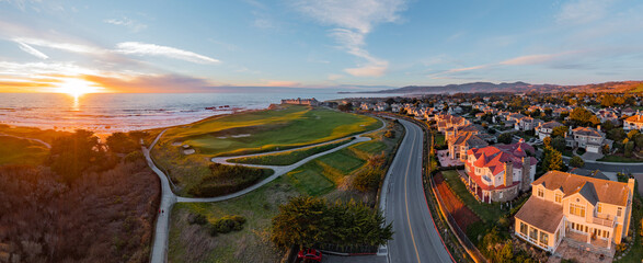 Aerial: Epic view of the town and the ocean at sunset. Drone view 