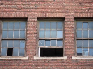 old brick building with broken windows