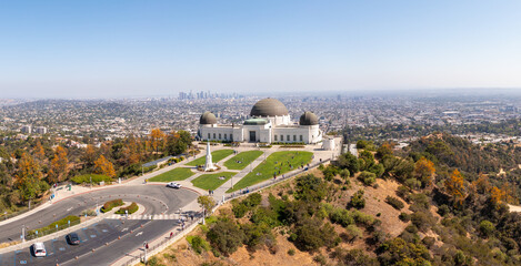 Aerial: Los Angeles cityscape and Griffith park. Drone View