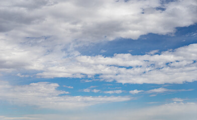 Fluffy white clouds and bright blue sky