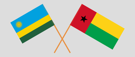 Crossed flags of Rwanda and Guinea-Bissau. Official colors. Correct proportion