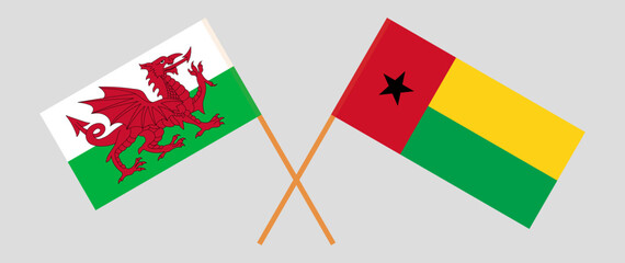 Crossed flags of Wales and Guinea-Bissau. Official colors. Correct proportion