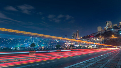Long exposure photography, light trails with car lights traffic and buildings with night lights and dark sky