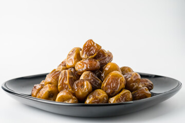 Delicious Sukari dates ( kurma sukari ) Much sought after during the month of Ramadan as a dish to break the fast, ramadhan kareem, in white background, empty space, copy space