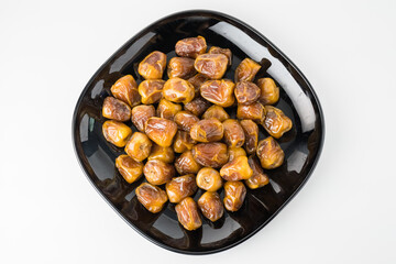 Delicious Sukari dates ( kurma sukari ) Much sought after during the month of Ramadan as a dish to break the fast, ramadhan kareem, in white background, empty space, copy space