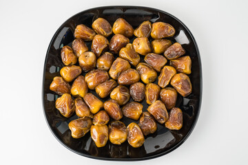 Delicious Sukari dates ( kurma sukari ) Much sought after during the month of Ramadan as a dish to break the fast, ramadhan kareem, in white background, empty space, copy space