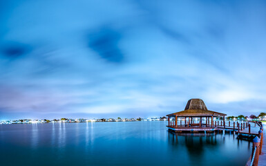 Panorama gazebo structure by the lagoon at night
