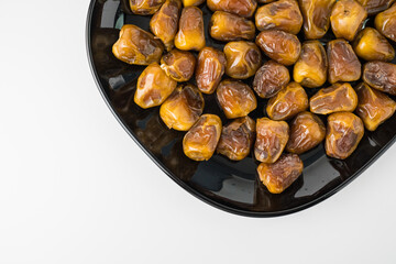 Delicious Sukari dates ( kurma sukari ) Much sought after during the month of Ramadan as a dish to break the fast, ramadhan kareem, in white background, empty space, copy space