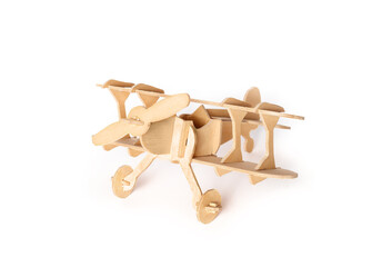 Isolated model wood plane. Wooden vintage double-decker plane or oldtimer airplane. Made of wood sections. Aviation or history of aircraft concept. Selective focus. White background.