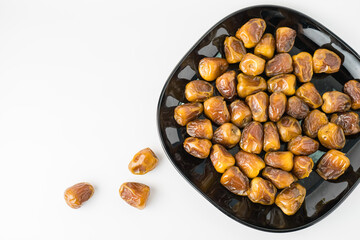 Delicious Sukari dates ( kurma sukari ) Much sought after during the month of Ramadan as a dish to break the fast, ramadhan kareem, in white background, empty space, copy space