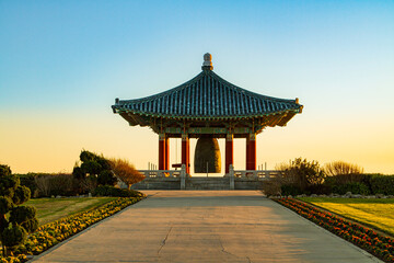 Traditional Korean design temple, gazebo, structure in the park at sunset 