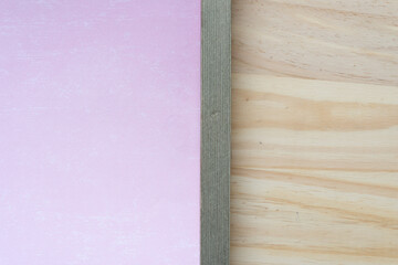 wood frame with pink paper backdrop and wood surface