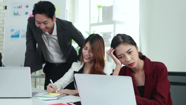 Asian woman suffering from back pain in the office