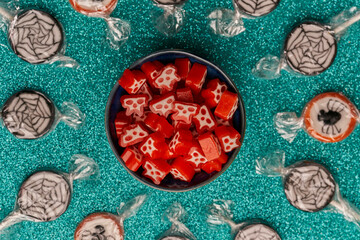 top view bowl of halloween candies on a bright background